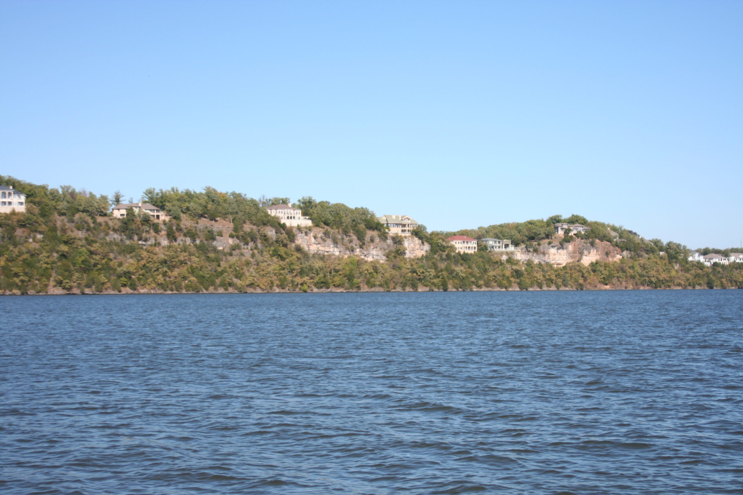Waterfront homes along a bluff at Lake of the Ozarks, seen from the water
